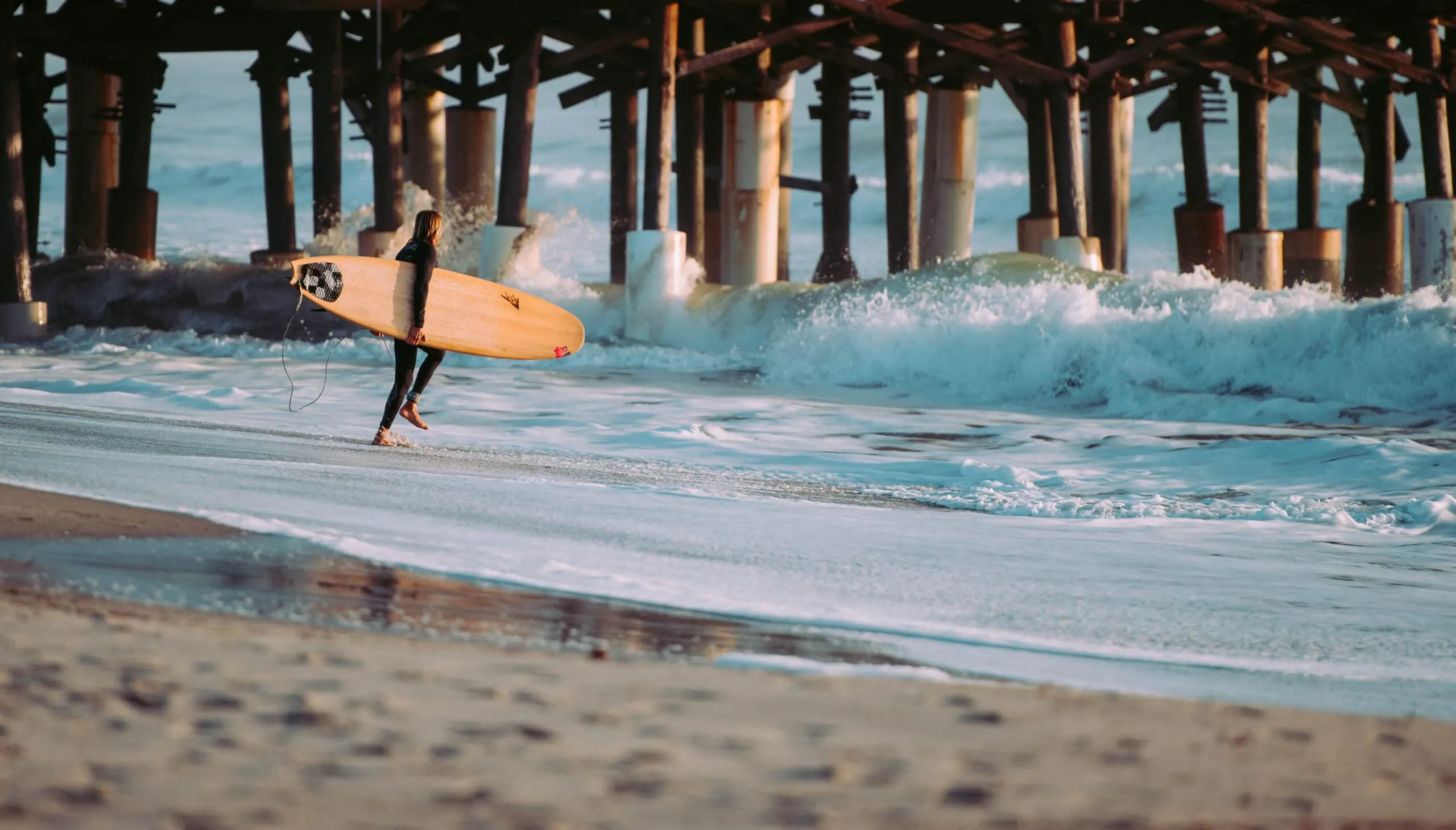 Surfer heading into the waves on Florida's Space Coast